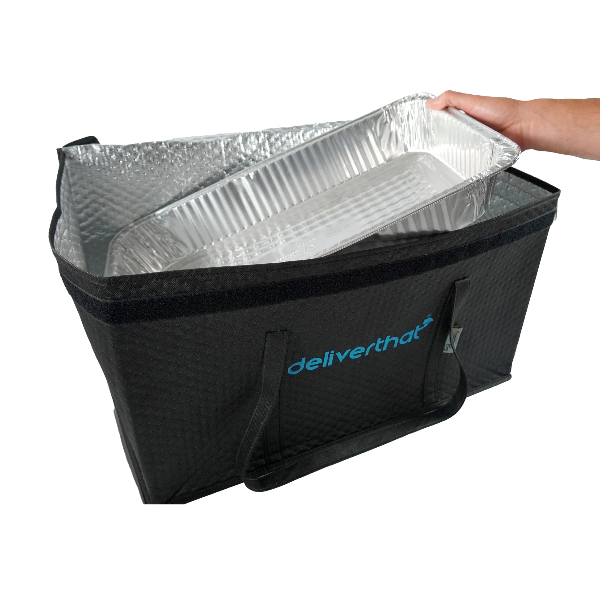 Black insulated food delivery bag with a foil tray inside, held by a hand on a white background.